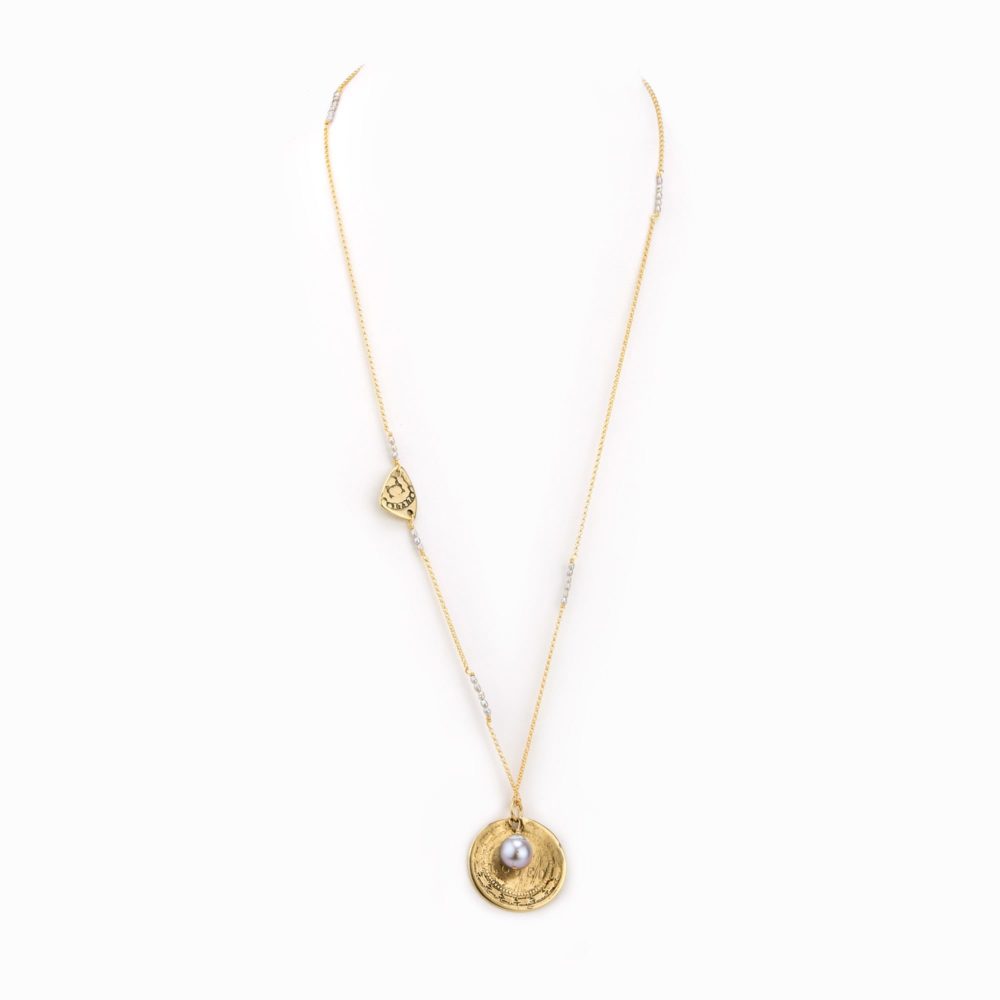 A delicate gold chain necklace with stamped gold coin charm and small pearl.