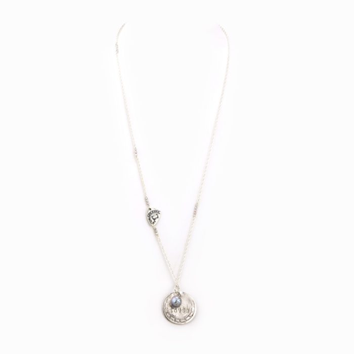 A simple necklace with delicate sterling silver chain, stamped silver coin charm, and small pearl.