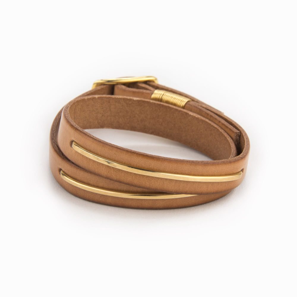 Tan leather bracelet with 14k gold filled metal inlay and buckle closure.