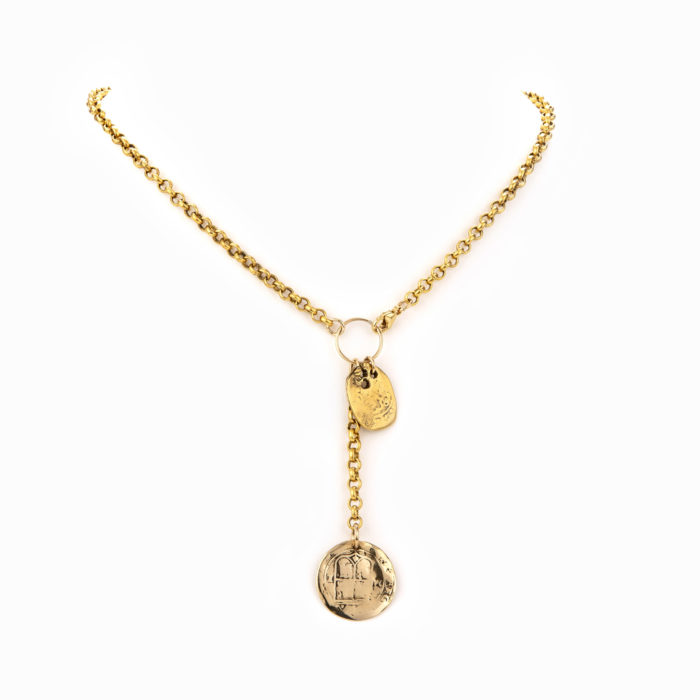 An adjustable front close necklace with thick brass chain and stamped gold coin charms.