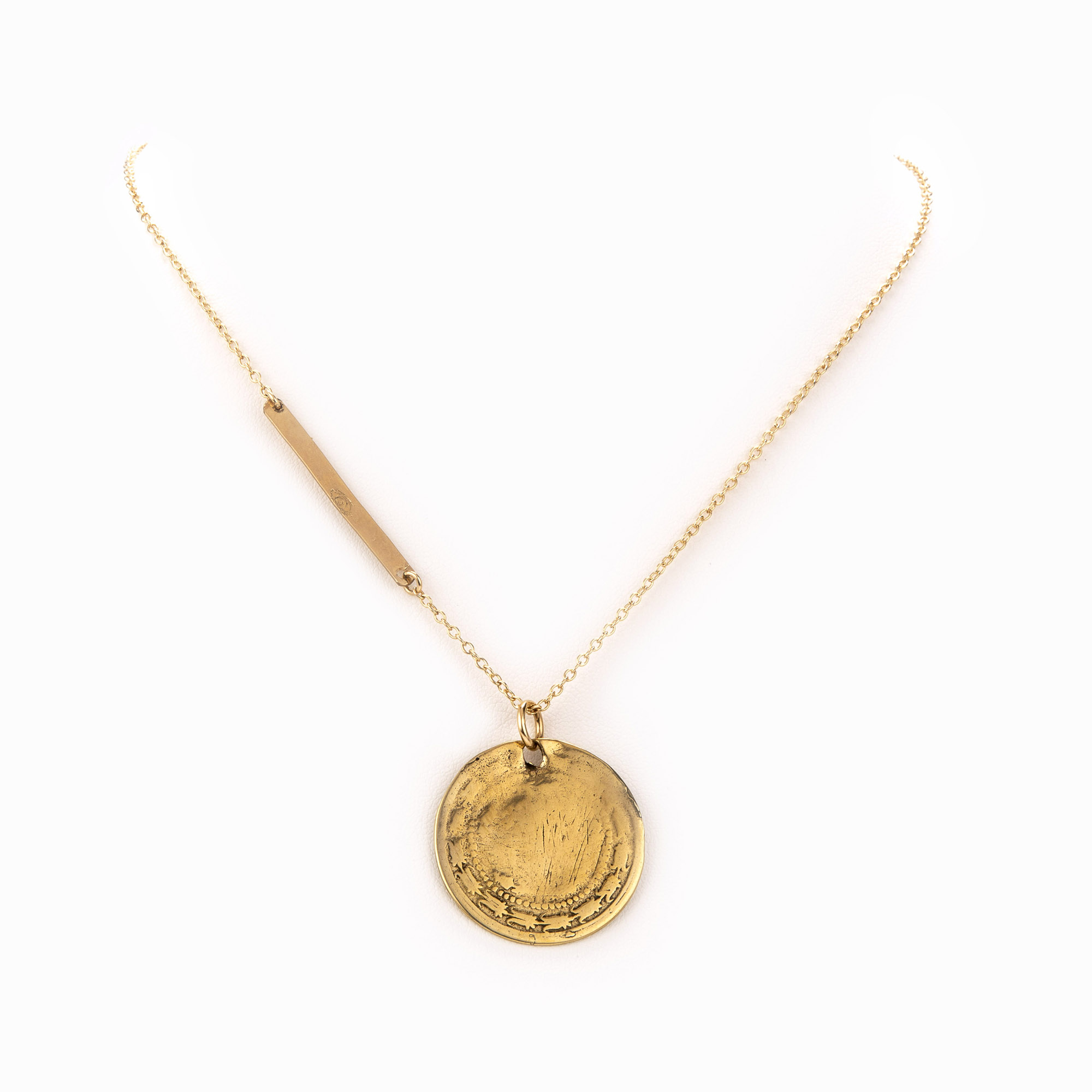A 14k gold-filled chain necklace mixed with a rich, gold bar and an antique coin.