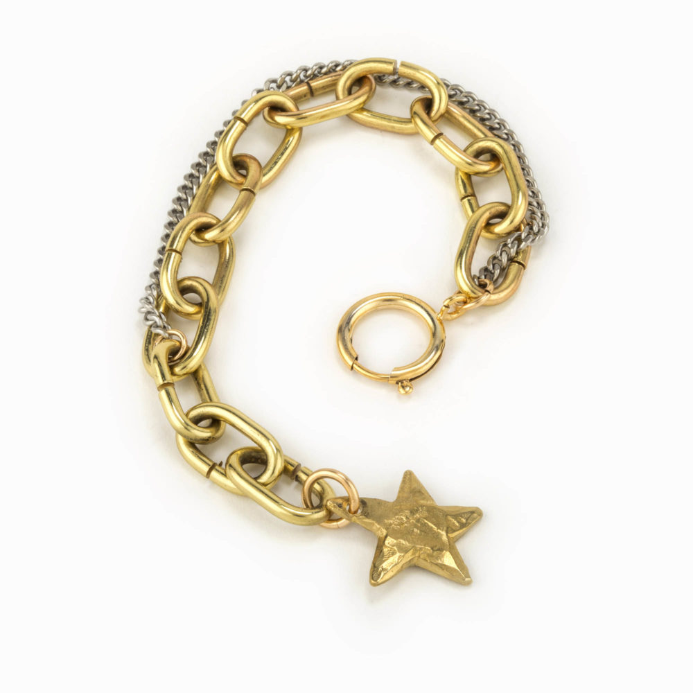 An adjustable brass chain bracelet intermixed with silver oxidized flat chain and a brass star.
