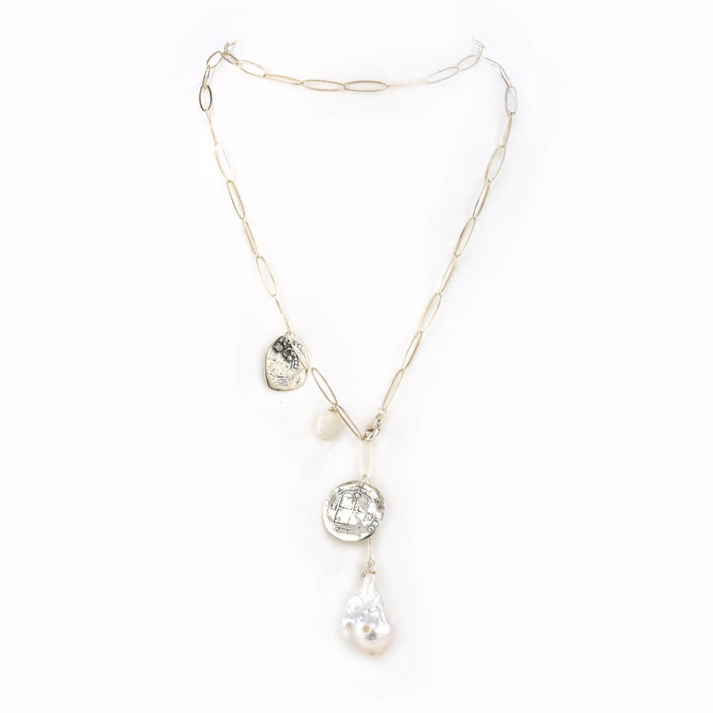 A sterling silver paperclip chain necklace with silver coin charm and large baroque pearl.