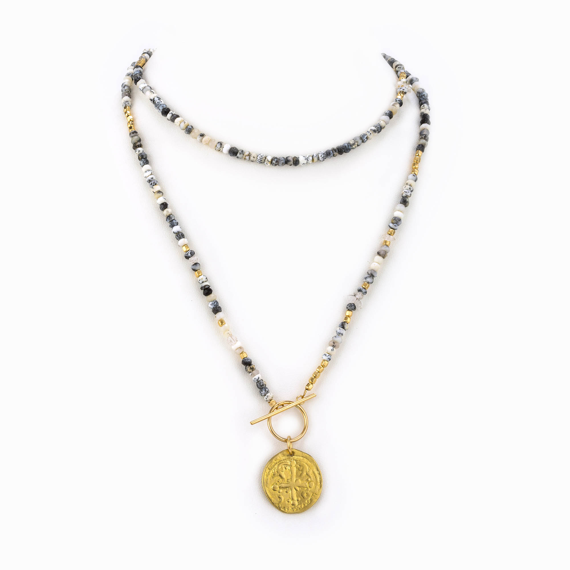 A necklace of multicolored grey and white agates, gold beads and Herkimer quartz with a brass antique coin.