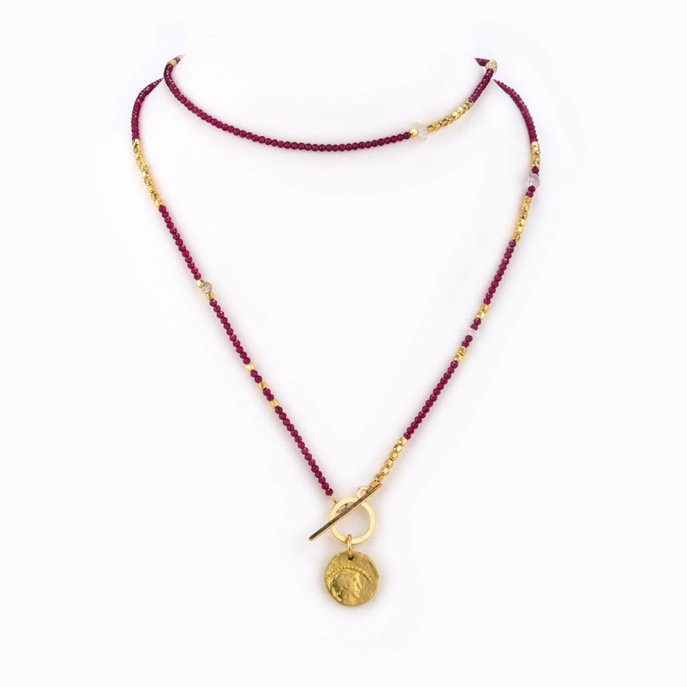 A multi garnet and gold African beaded chain necklace with adjustable 14k gold fill closure and antique coin.
