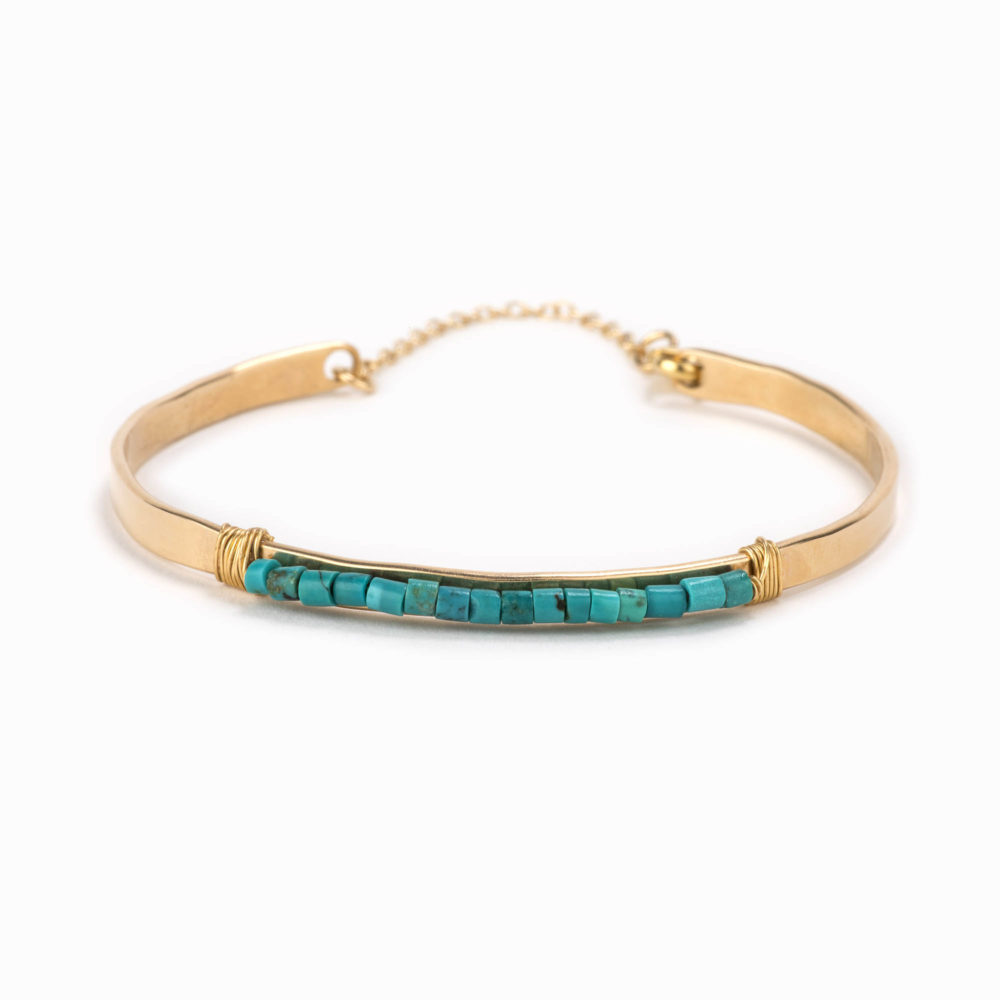 An adjustable 14k gold filled bracelet with wire wrapped turquoise beads.