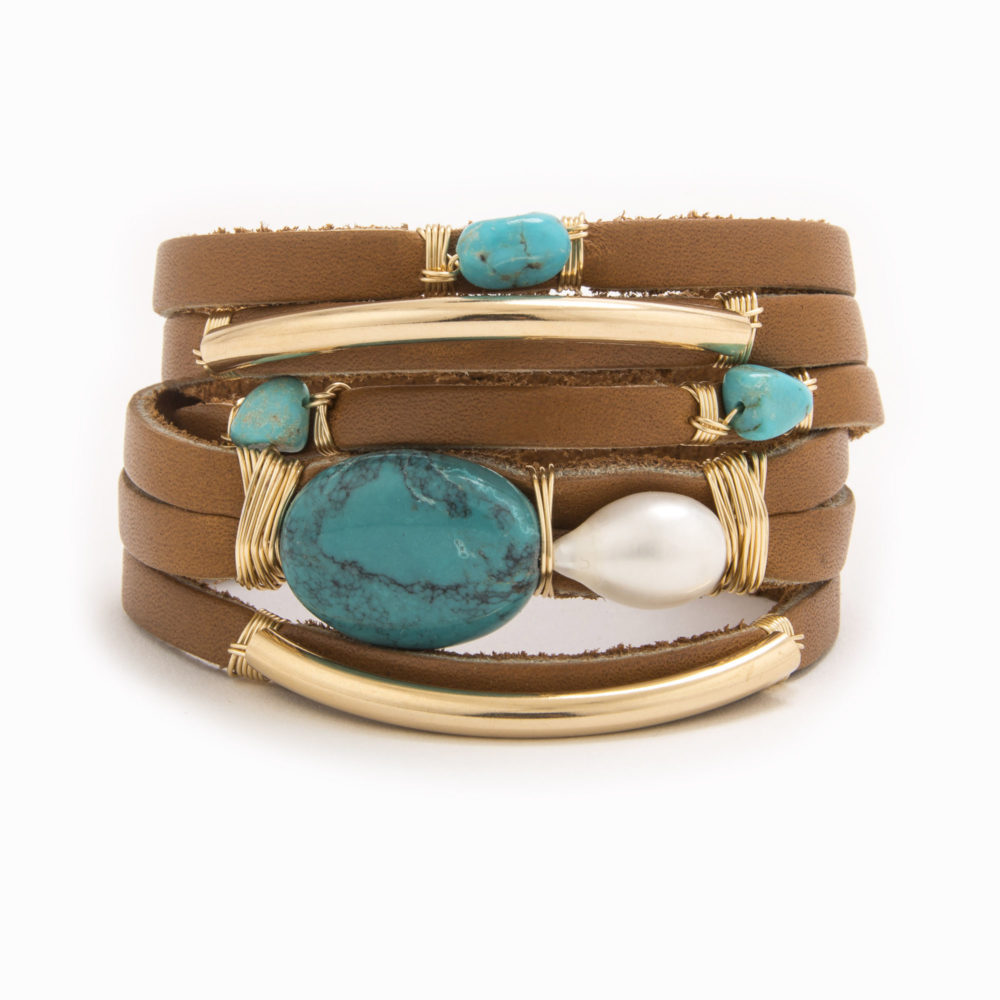 A tan-colored leather bracelet with wire wrapped in 14k gold fill tubes with scattered turquoise and fresh water pearls.