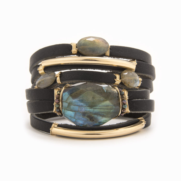 A smooth, black-colored leather bracelet with wire wrapped in 14k gold fill tubes with labradorite.
