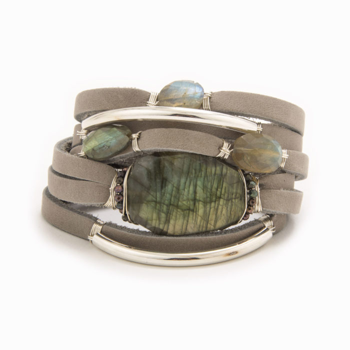 A taupe-colored leather wrap bracelet with wire wrapped in sterling silver tubes and labradorite stones.