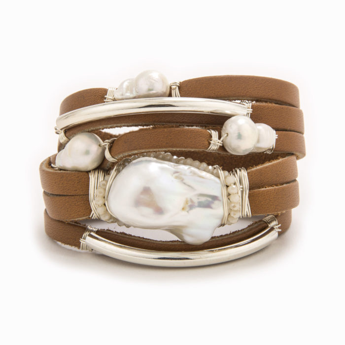 A smooth, tan-colored leather shred bracelet with wire wrapped in sterling silver tubes with scattered baroque and fresh water pearls.