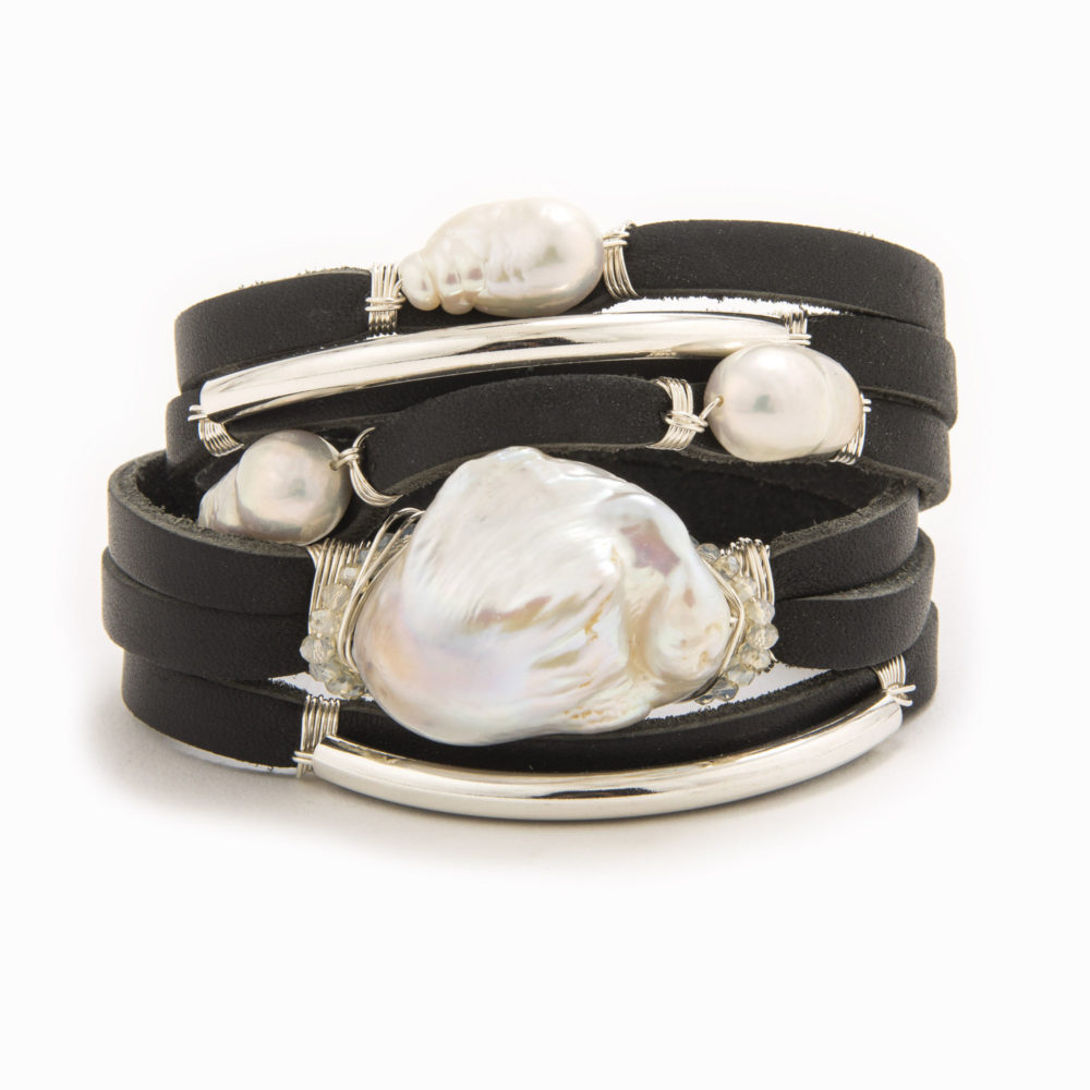 A black-colored leather wrap bracelet with wire wrapped in sterling silver tubes with baroqoe and fresh water pearls.