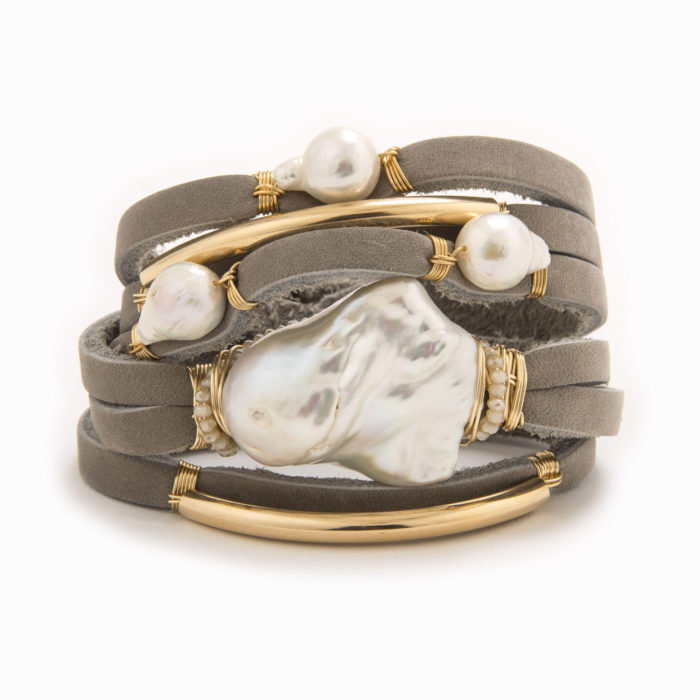 A taupe-colored leather wrap bracelet with wire wrapped in 14k gold fill tubes with baroque and fresh water pearl.