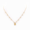 A 14k gold-filled chain necklace with a brass pebble and Herkimer quartz pieces.