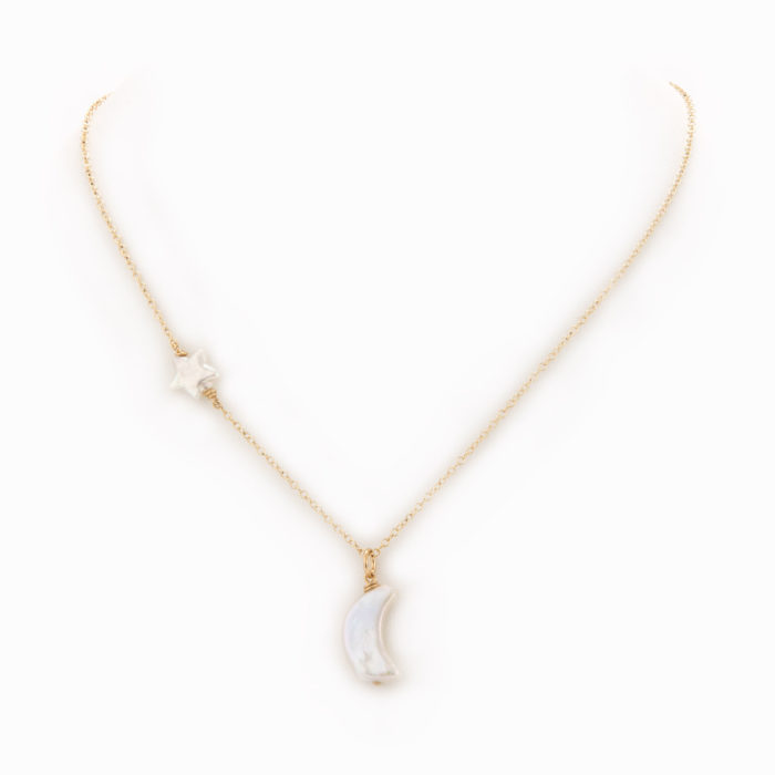 A delicate necklace with 14k gold-filled chain with a white pearl star and moon charm.