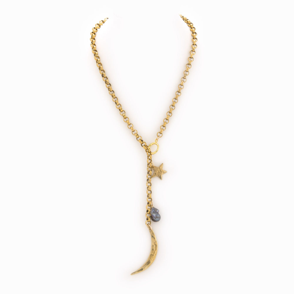 A brass rolo chain necklace with an oversized clasp and finshed with a brass moon, star and black pearl.