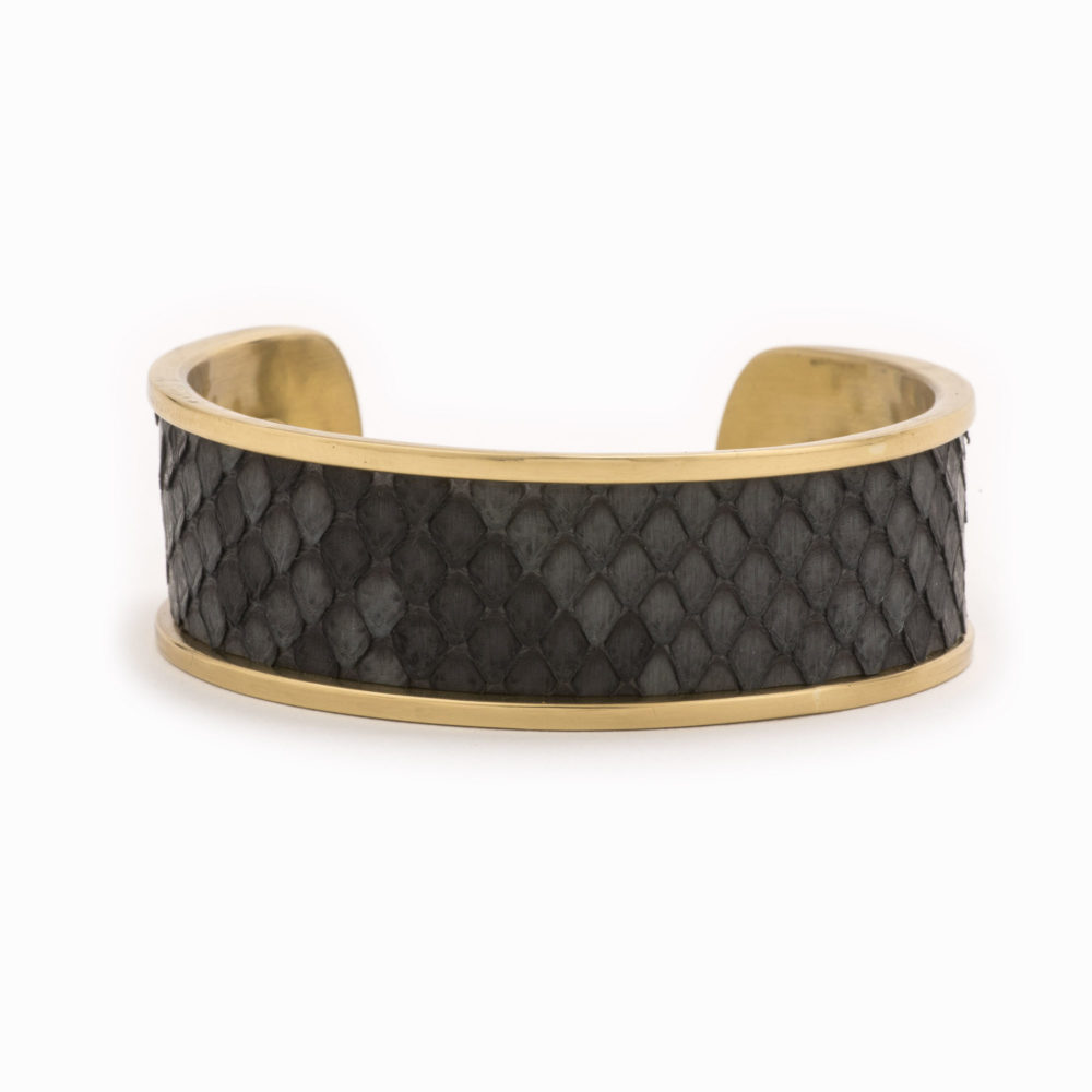 A medium gold cuff with charcoal colored snakeskin pattern inlaid.