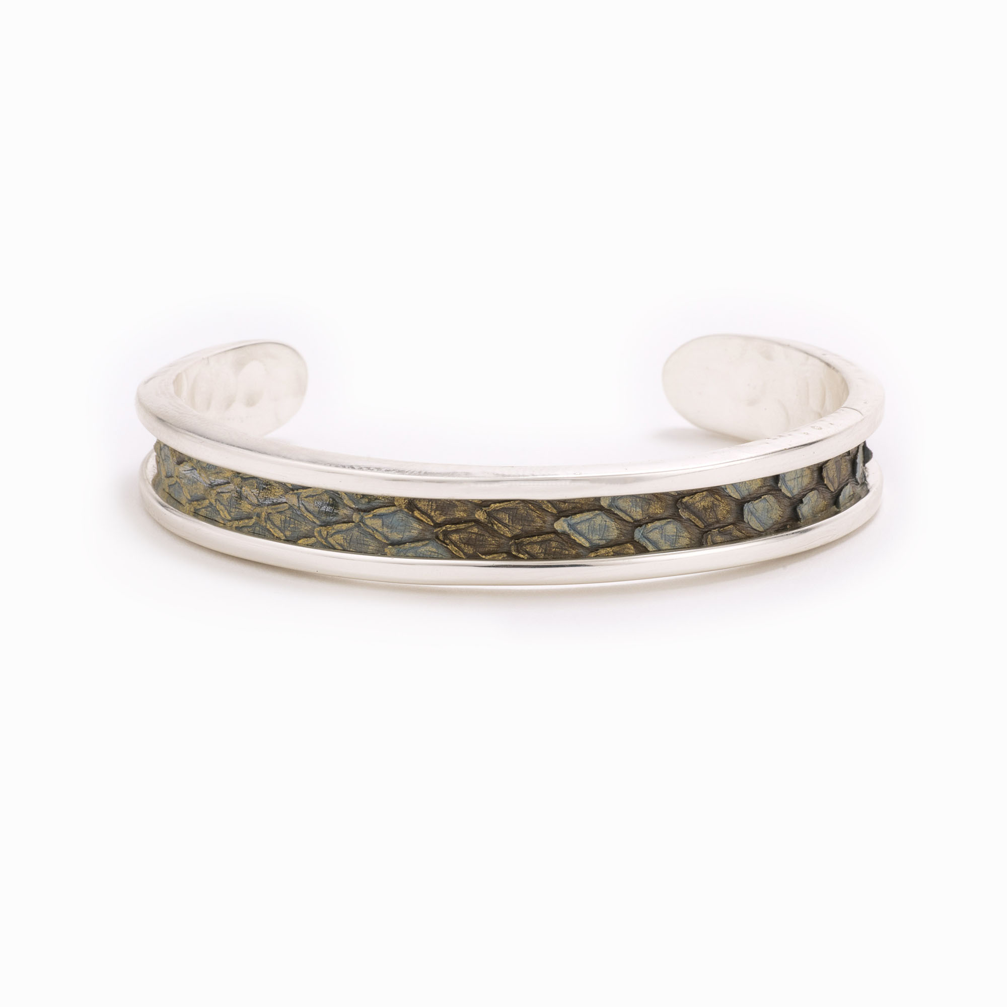 A small silver cuff with blush colored python skin pattern.