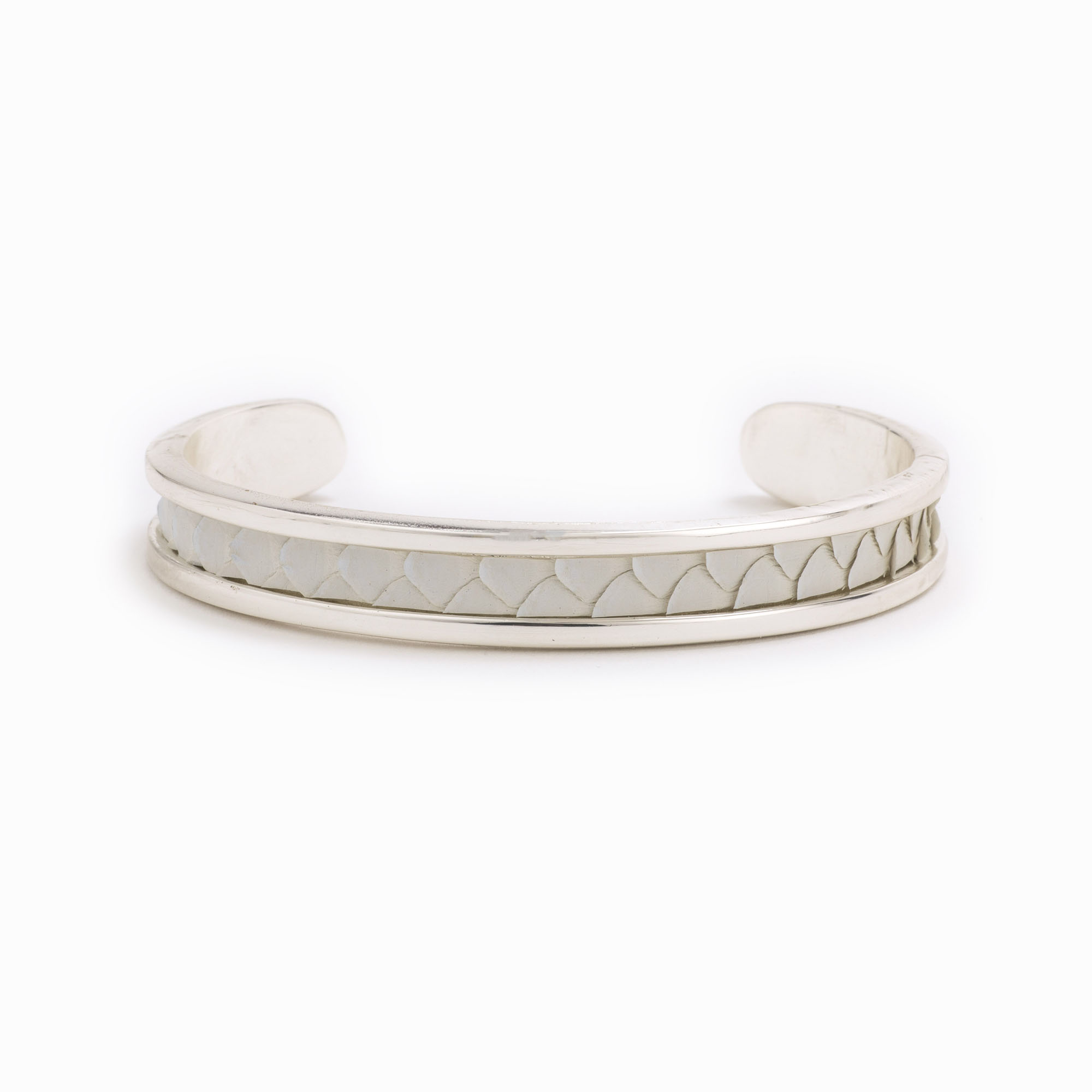 A small silver cuff with white colored snakeskin pattern inlaid.