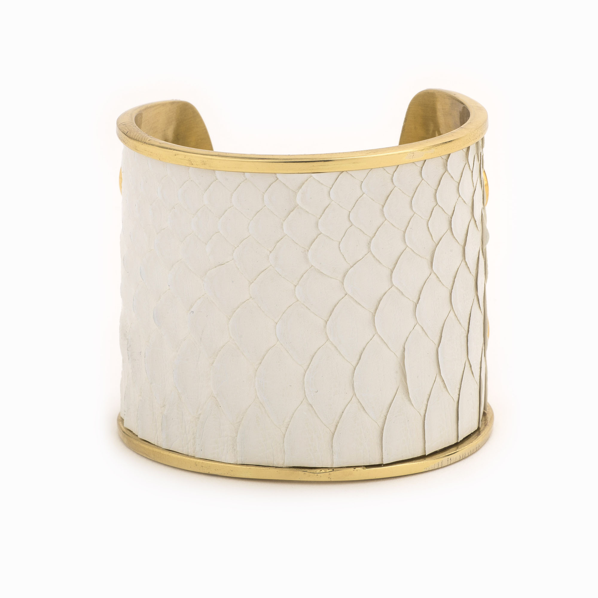 Large gold cuff with white snakeskin pattern.
