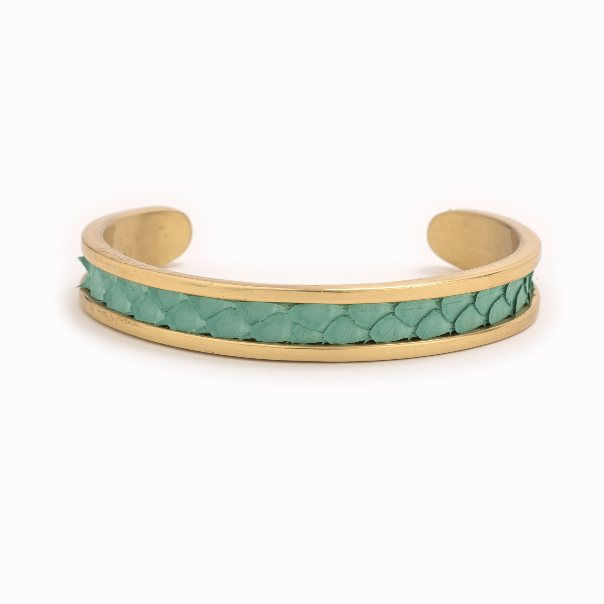 A small gold cuff with turquoise colored snakeskin pattern inlaid.