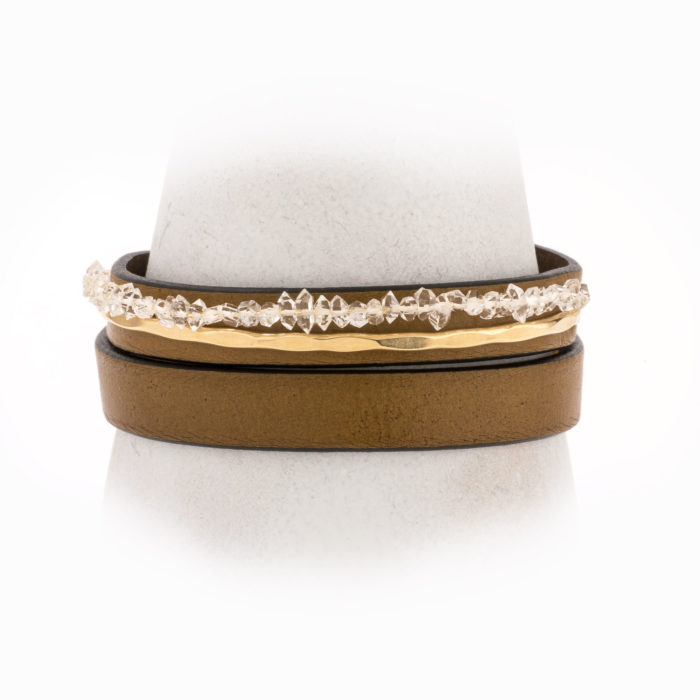 An adjustable, tan leather wrapped bracelet with 14k gold-filled, hand-forged wire and Herkimer crystals.