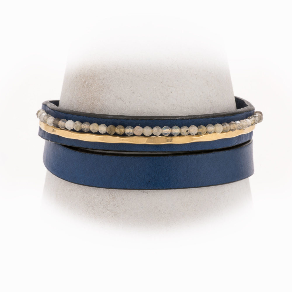 An adjustable, navy leather wrapped bracelet with 14k gold-filled hand-forged wire and labradorite.