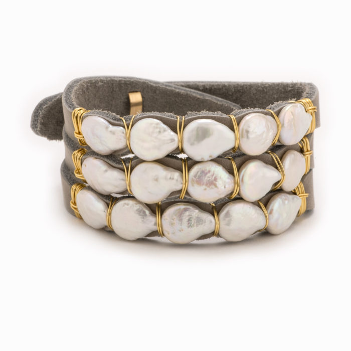 An adjustable taupe leather bracelet with 14k gold fill wire and pearls.