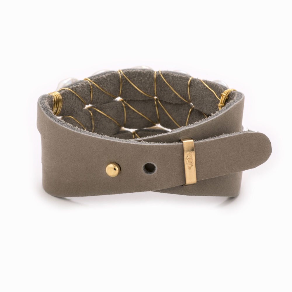 An adjustable taupe leather bracelet with 14k gold fill wire and pearls.