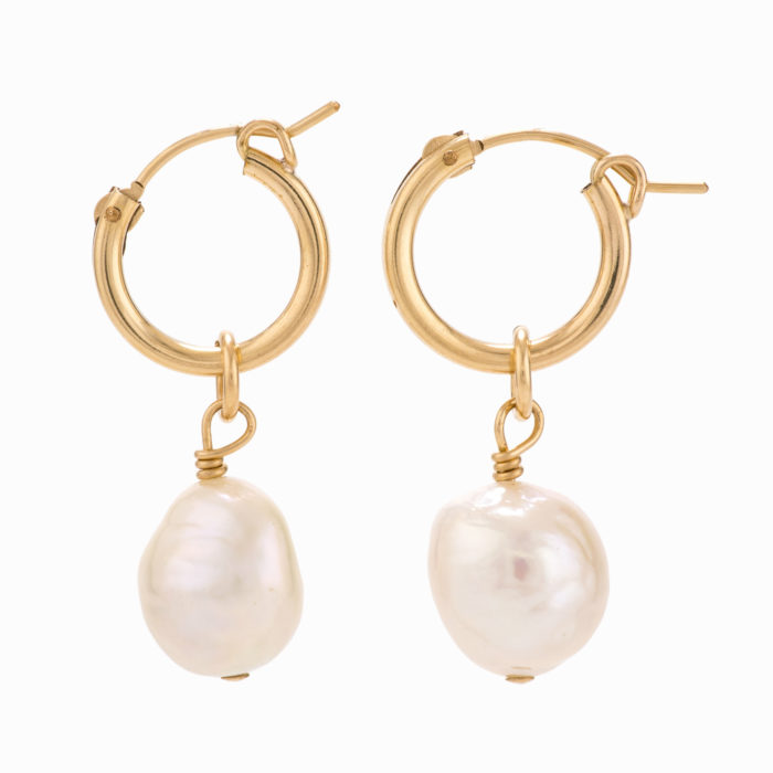 A pair of simple gold hoop earrings with white pearls.