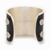 A large silver cuff with black snakeskin pattern inlay.