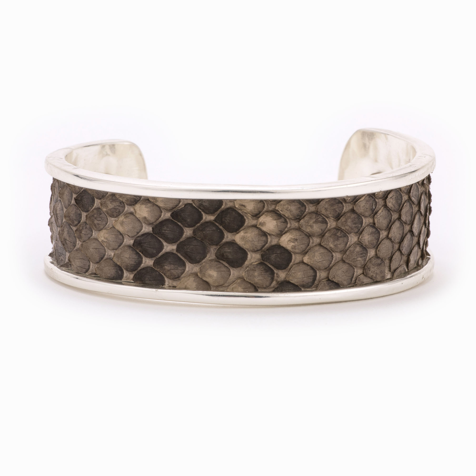 A medium silver cuff with grey and brown colored snakeskin pattern inlaid.