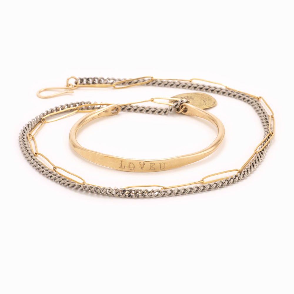 An uncoiled wire wrap bracelet with oxidized sterling silver chain and 14k gold fill paperclip chain wrap as well as ‘loved’ stamped 14k gold fill bar with added antique coin detail