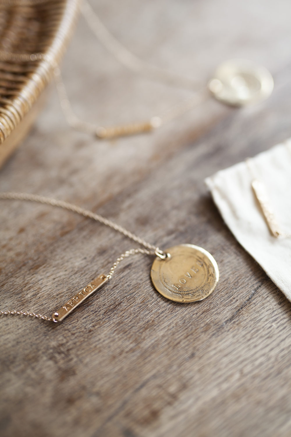 Close up of a gold chain necklace on a wooden table.